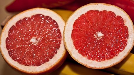 Vibrant Grapefruit Slices Displayed Beautifully wallpaper