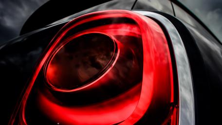Sleek Car Tail Light Design in Vibrant Red Shades wallpaper