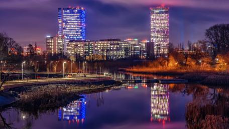 Vibrant Cityscape Reflected in Water at Night wallpaper