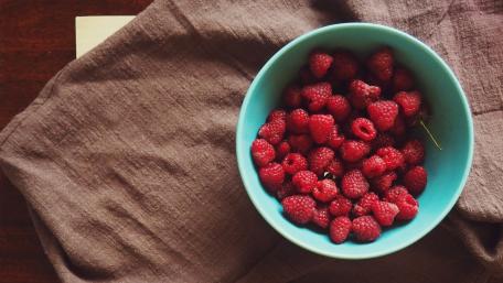 Fresh Raspberries in a Vibrant Blue Bowl wallpaper