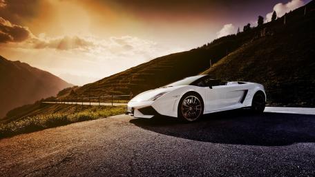 Sleek White Supercar Against a Stunning Landscape wallpaper