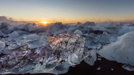 Shimmering Ice and Waves at Sunset wallpaper