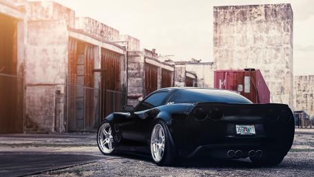 Sleek Black Sports Car in Urban Setting wallpaper