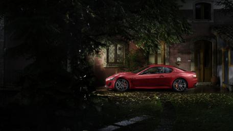 Sleek Red Sports Car in a Serene Night Setting wallpaper