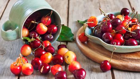 Vibrant Cherries on Rustic Tabletop wallpaper