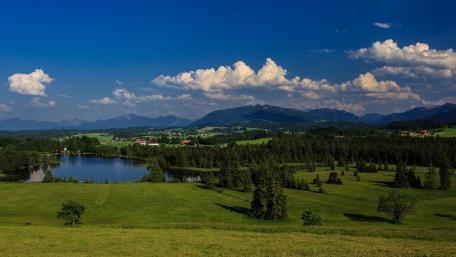 Serene Landscape with Majestic Mountains and Lush Greenery wallpaper