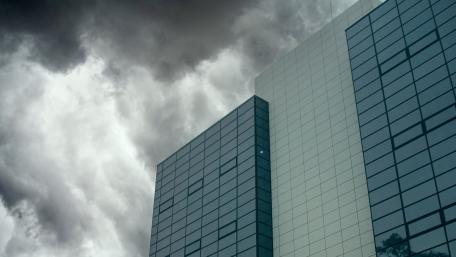 Urban Reflections Beneath Ominous Skies wallpaper