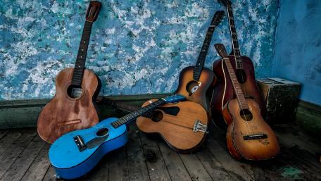 Abandoned Guitars in a Rustic Setting wallpaper