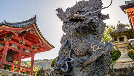 Majestic Dragon Guardian in a City Landscape wallpaper