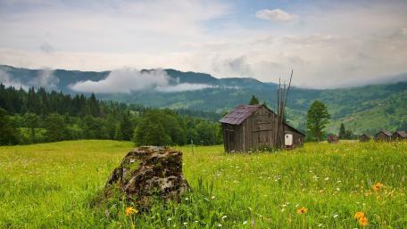 Serene Mountain Landscape with Rustic Cabin wallpaper