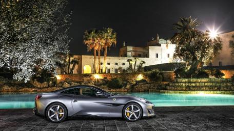 Sleek Luxury Sports Car by the Poolside at Night wallpaper