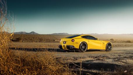 Vibrant Yellow Sports Car in Desert Landscape wallpaper
