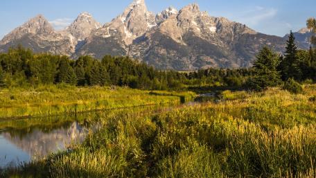 Majestic Mountains Reflected in Tranquil Waters wallpaper