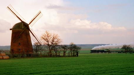 Tranquil Scenery of Windmill and Train in Nature wallpaper