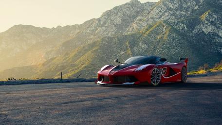 Stunning Red Sports Car Against Mountain Backdrop wallpaper