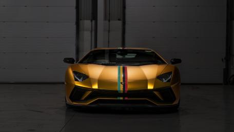 Radiant Golden Supercar in a Dimly Lit Garage wallpaper