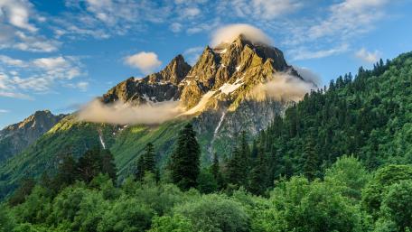 Majestic Mountain Peaks Embraced by Clouds wallpaper