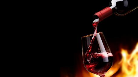 Pouring Wine with a Fiery Backdrop wallpaper