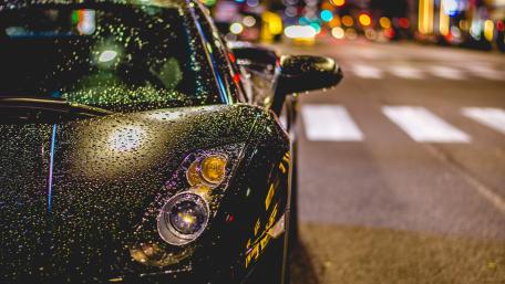 Sleek Rainy Night Car Reflection Wallpaper wallpaper
