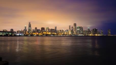 Vibrant Night Cityscape Over Water wallpaper