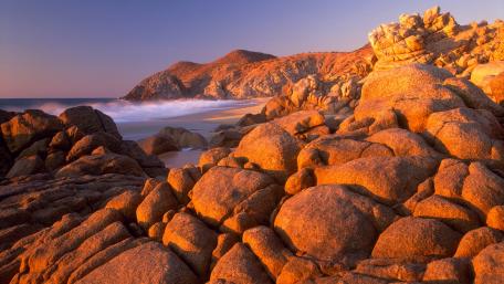 Golden Sunset Over Rocky Coastline wallpaper