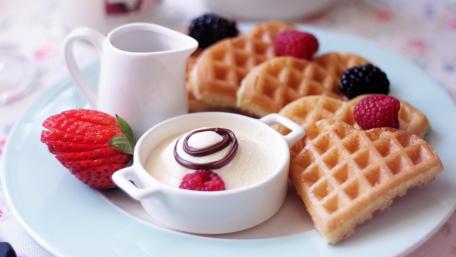Delightful Waffle Feast with Fresh Berries and Creamy Dip wallpaper