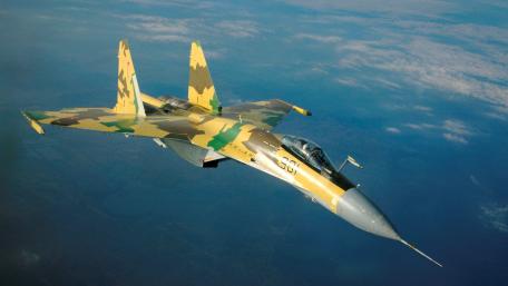 Camouflaged Fighter Jet in Flight wallpaper