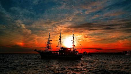Majestic Ship Against Vibrant Sunset wallpaper