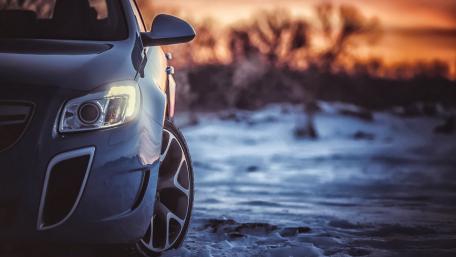 Sleek Car in Winter Wonderland Scene wallpaper