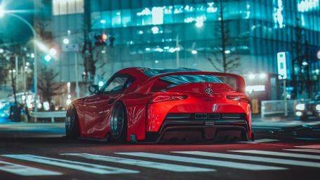 Sleek Red Sports Car in Urban Night Scene wallpaper
