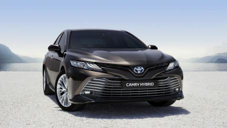 Sleek Toyota Camry Hybrid in a Serene Landscape wallpaper