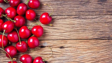 Fresh Cherries on Rustic Wood Background wallpaper