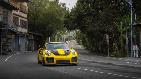 Vibrant Yellow Sports Car in Motion wallpaper
