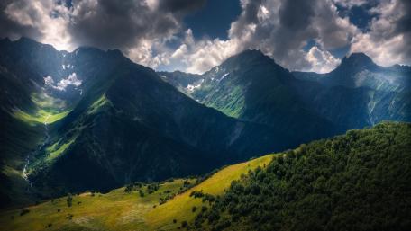 Majestic Mountain Landscape Under Dramatic Skies wallpaper