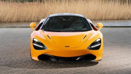 Sleek Orange Supercar with Bold Design Features wallpaper