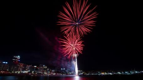 Dynamic Fireworks Illuminate the Night Sky in the City wallpaper