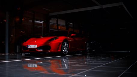 Sleek Red Sports Car in Dim Light wallpaper