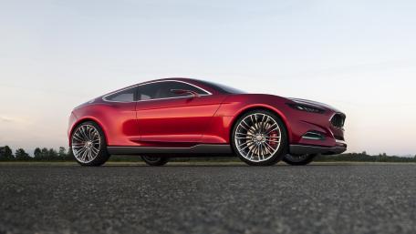 Sleek Red Sports Car on the Open Road wallpaper