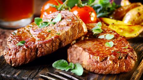 Sizzling Steaks and Fresh Vegetables Delightful Dining Experience wallpaper