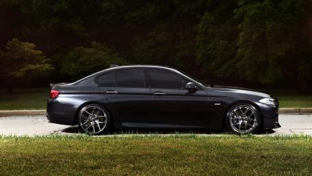 Sleek Black Sedan in Nature wallpaper
