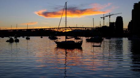 Serene Sunset Reflection Over a Tranquil Harbor wallpaper