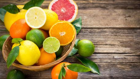 Fresh and Vibrant Citrus Fruits in a Basket wallpaper