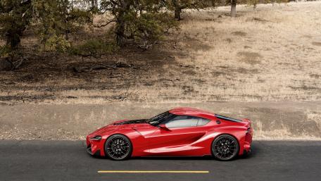 Sleek Red Sports Car on Open Road wallpaper