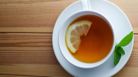 Refreshing Lemon Tea on a Wooden Table wallpaper