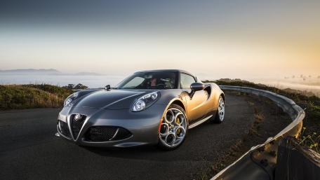 Sleek Alpha Romeo on an Open Road at Sunrise wallpaper