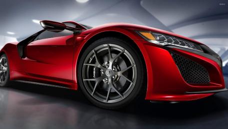 Sleek Red Supercar in Modern Setting wallpaper
