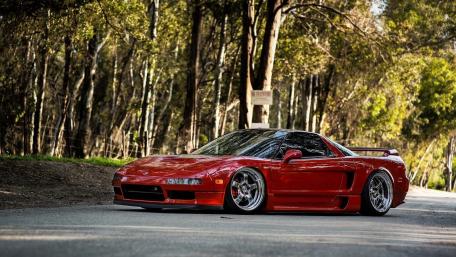Classic Red Sports Car in Nature Setting wallpaper