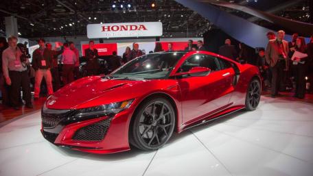 Sleek Red Sports Car Showcasing Modern Design and Power wallpaper