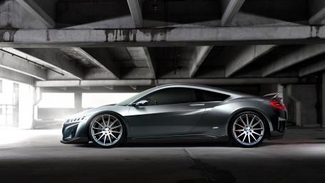 Sleek Next-Gen Sports Car Under Concrete Archways wallpaper