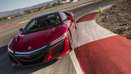 Sleek Red Sports Car Racing on the Track wallpaper